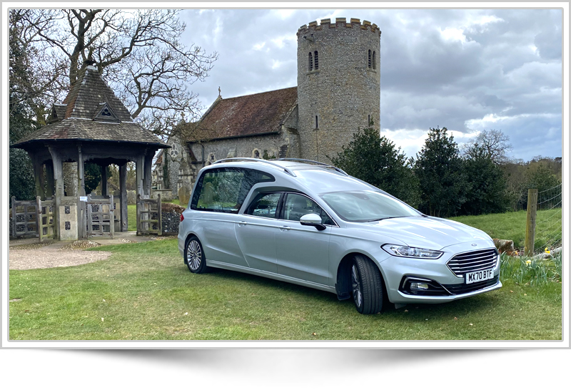 Funeral procession vehicle at cemetery